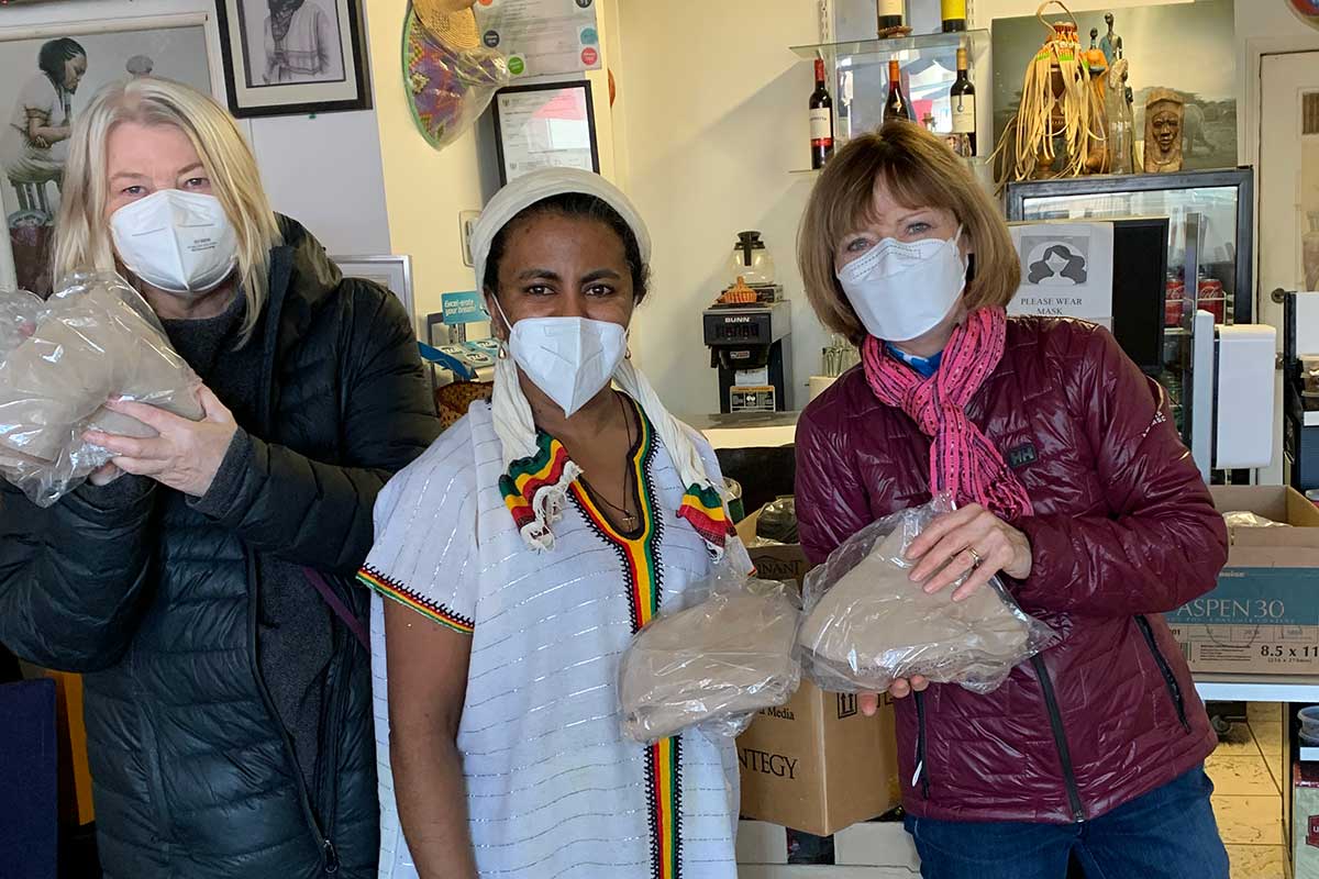 Daphne Fry, Blue Nile owner Tsedey Kassa, and Marian McGrath packing injera for take-out meals.