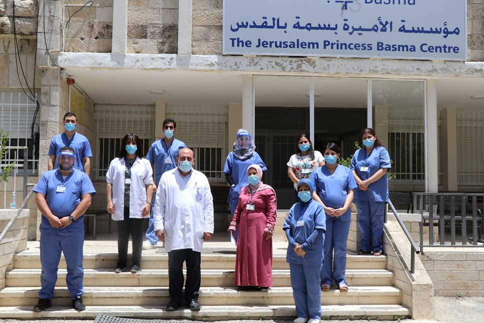 Staff in front of Basma Hospital