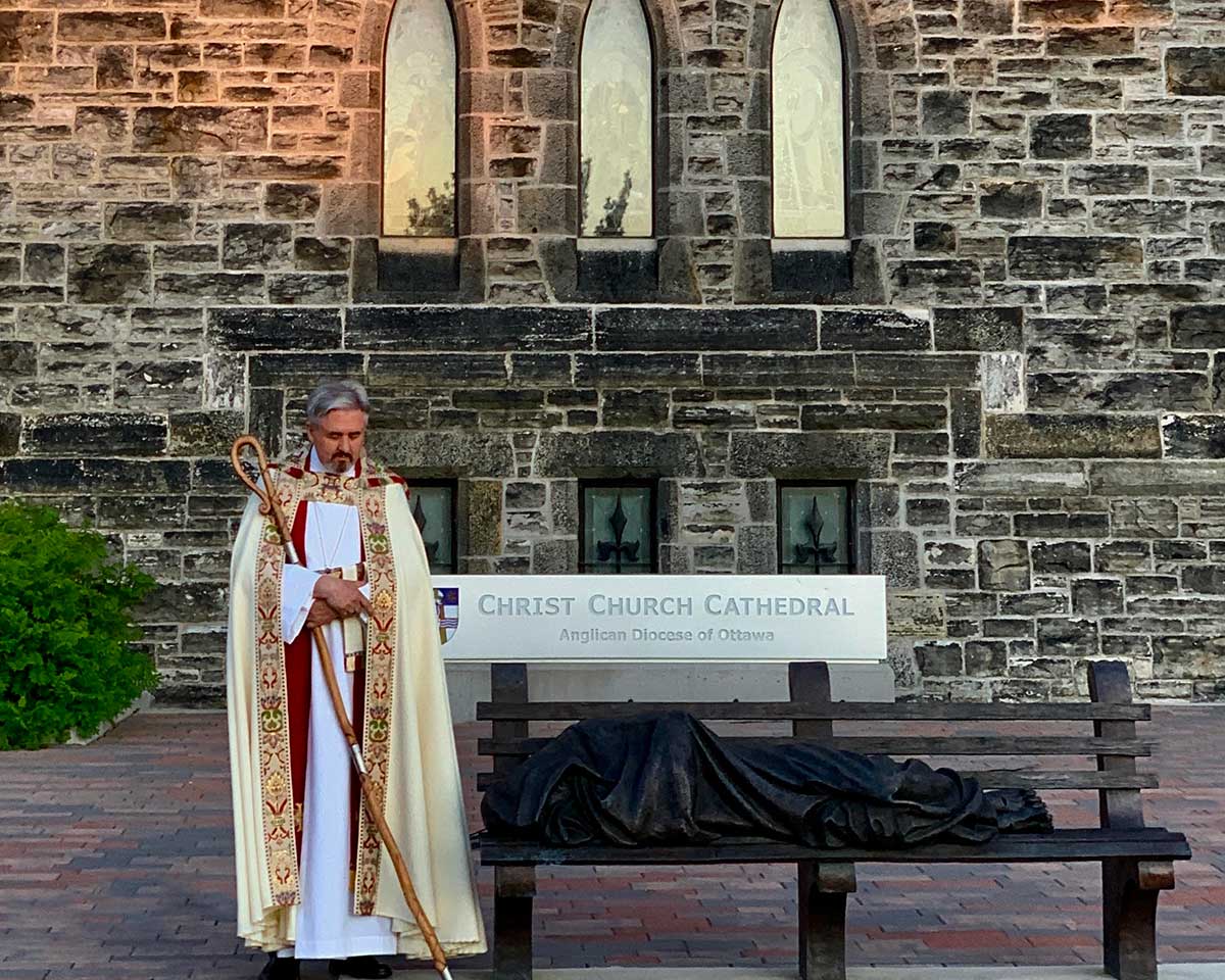 Bishop Shane praying in front of Christ Church Cathedral
