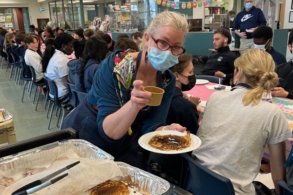 Teacher Sarah Murray serving pancakes to the winning class.