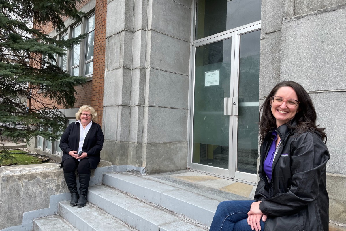 Patricia Hassard and Sarah Davis at the doors of Cornerstone's new building.
