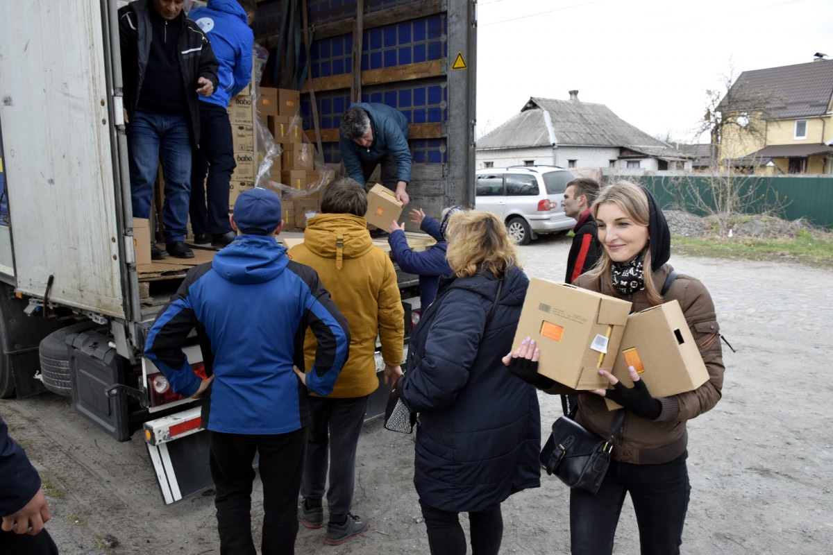 A young woman and others in the Village of Glibivka received supplies from a Hungarian Interchurch Aid truck.