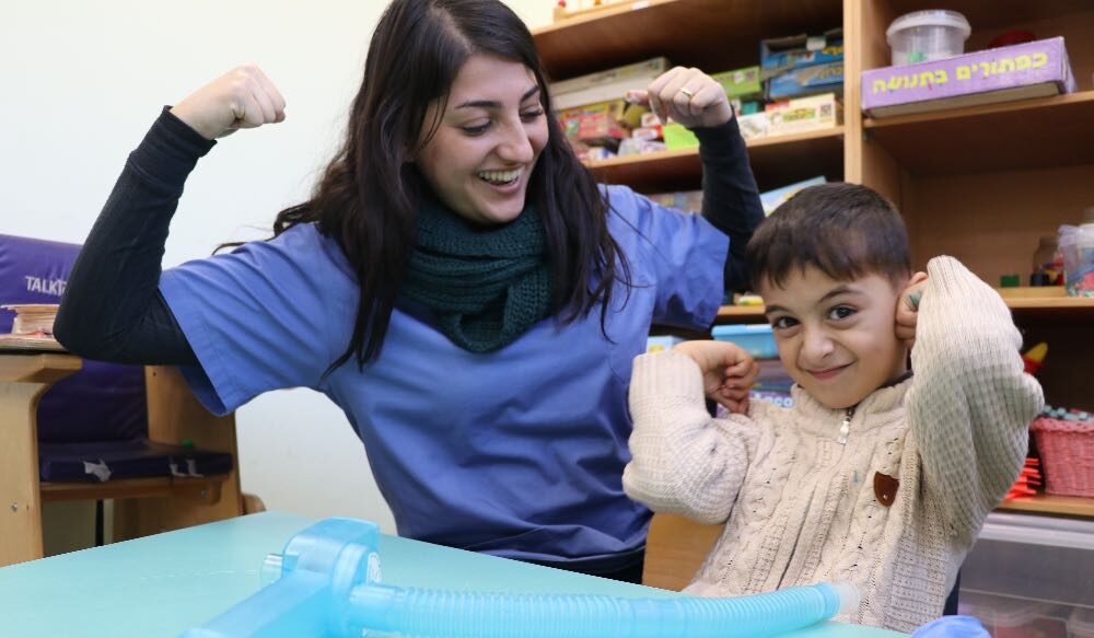 A young boy and his speech therapist at the Princess Basma Centre.