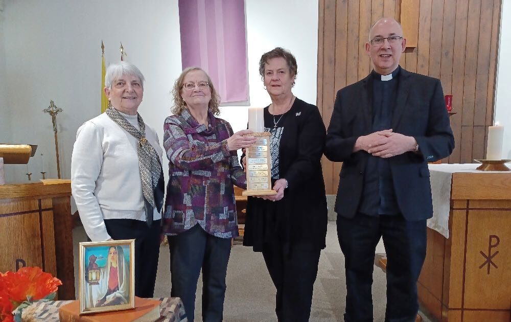 Donna McMillan and Caroll Carkner accept the World Day of Prayer candle.