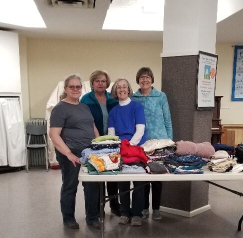 Mary Anne Reinhard, Pam Hazen, Arlene Simonovich and Diane Clement sort clothes.