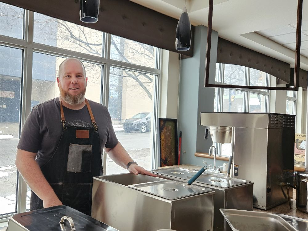 The Rev. Michael Garner of St. Albans preparing to serve dinner at a University of Ottawa residence.