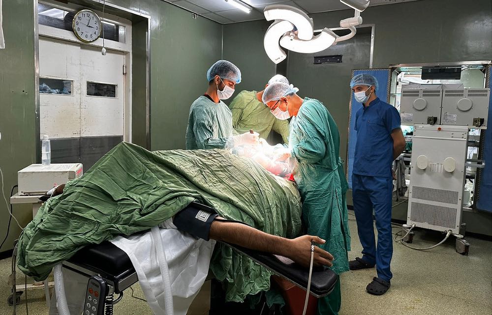 Doctors at the Al-Ahli Hospital in Gaza operate on a patient’s leg