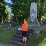 The Rev. Canon Catherine Ascah speaks to St. Bart's parishioners in Beechwood Cemetery.