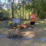 Chris Silvermoon-Cutler leaves a message for Dr. Peter Bryce at his grave.