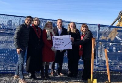 Politicians and partners in the Odenak housing project pose for a photo on site. Photo: Leigh Anne Williams