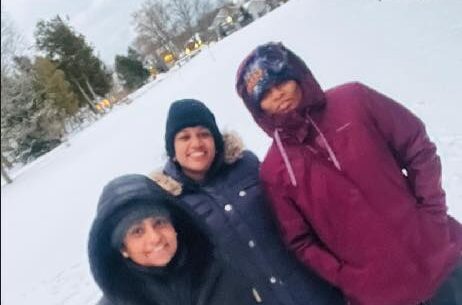 Nurses dressed in warm winter hats and coats.