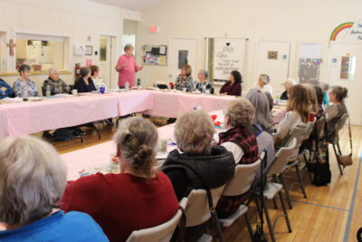 Anne Mains, founder and president of the Russell Friends of Victoria Quilts, provides an overview of the past 20 years of the organization during the celebratory luncheon.