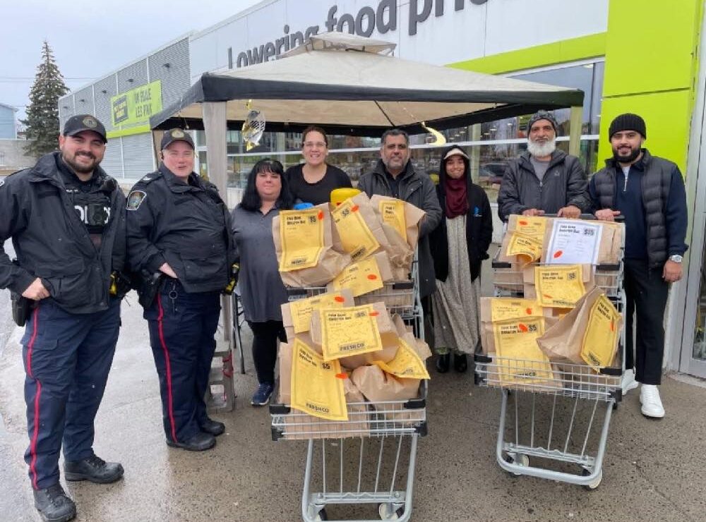 Representatives from the Islamic Foundation of Cornwall, the Cornwall Police Service and Freshco during the Ramadan Community Food Drive.