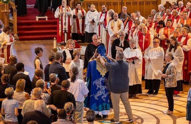 Clergy and lay representatives from the diocese of Ottawa assist Archbishop Parker vesting.