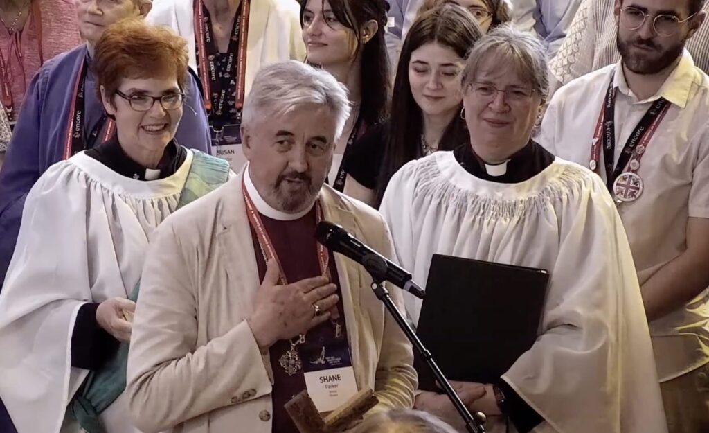 Primate-elect Shane Parker surrounded by Synod delegates and clergy.
