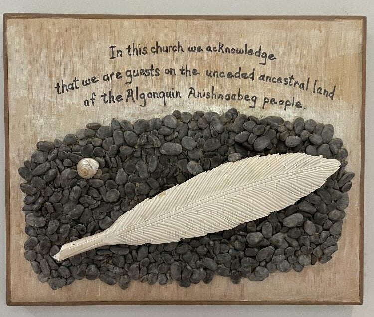 Feather at Epiphany is set on small stones like one would find at a river