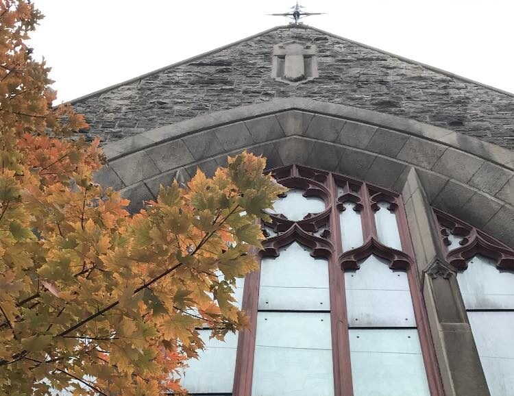 Exterior view of Christ Church Cathedrals window and fall leaves