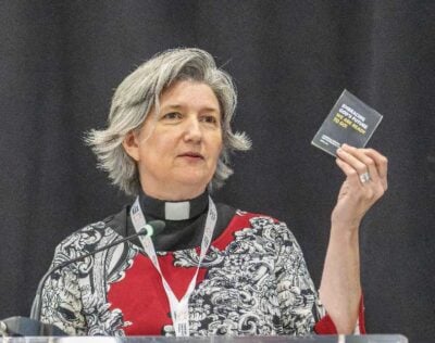 Archdeacon Monique Stone holds a copy of a strategic plan from 2014 "Embracing God's Future."