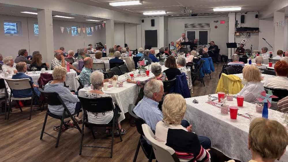 A gathering of people at St. James Manotick enjoying some live music.