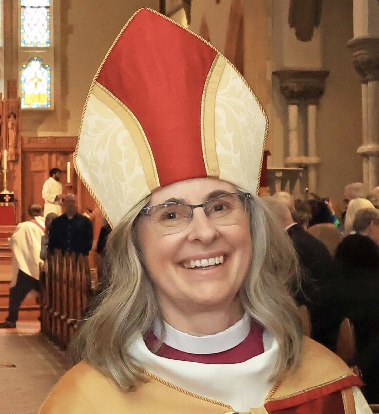 Head and shoulders photo of Bishop Kathryn Otley wearing a red and gold mitre.