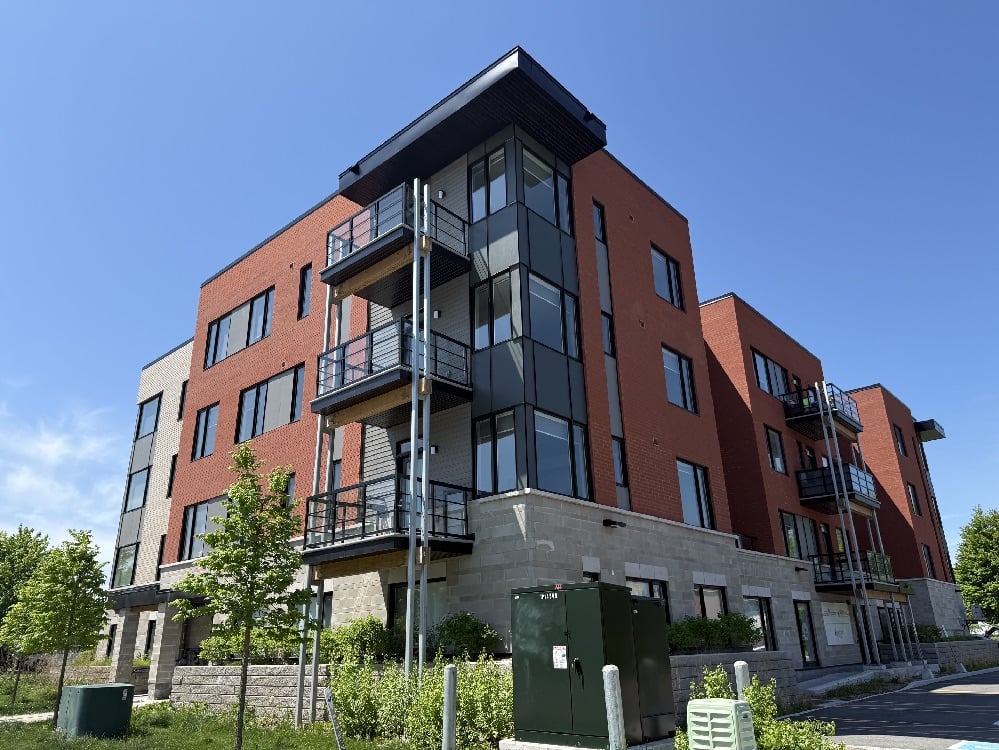Exterior view of Hollyer House (brick) on a sunny summer day.