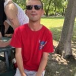 Calley in a red t-shirt and sunglasses outside at Dundonald Park