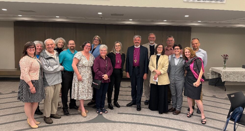 Editors pose for a photo with Bishop Kathryn Otley and Archbishop Shane Parker. Photo: Contributed