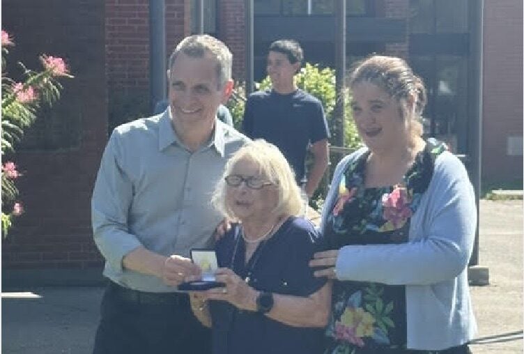 Mayor Mark Sutcliffe with Janice Horton and Councillor Marty Carr after the coin was presented. Photo: Michele Bédard