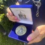 Close view of commemorative coin in a blue box