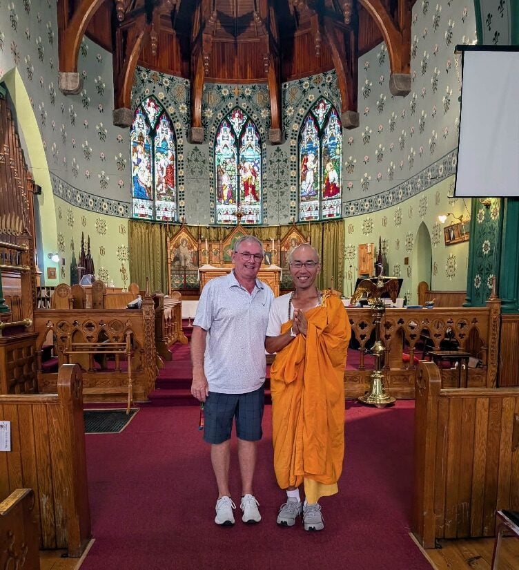 The Rev. Mark Lewis with he Venerable Kanshin Ikeda wearing the saffron coloured robe of a Buddist monk in the interior of St. James Church in Morrisburg, Ont.