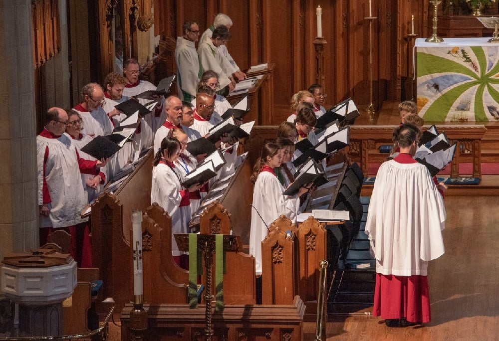 Choir members singing in Christ Church Cathedral Ottawa in red and white robes
