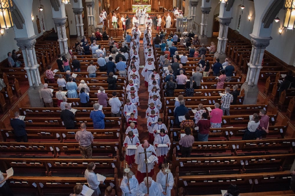 Choir members processing out of Christ Church Cathedral Ottawa viewed from above.
