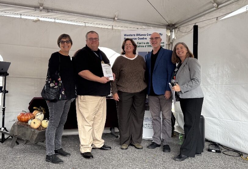 Parish representatives stand and smile with WORCC executive director and staffer holding a certificate.