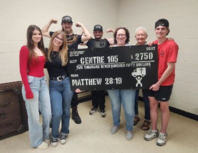 Centre 105 staff and volunteers gathered to accept donations from the Two-Strong-Boys walkathon.
