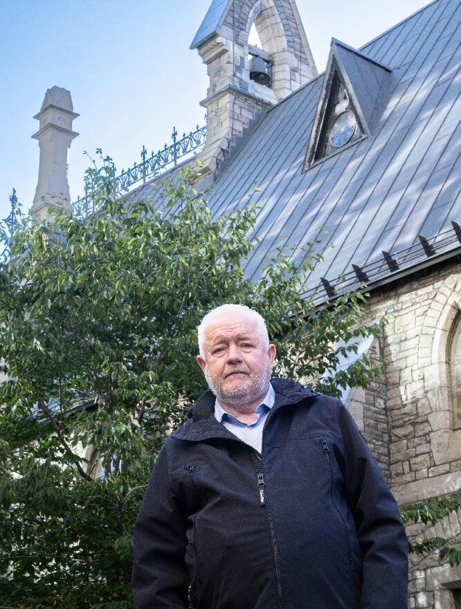 Mark MacDonald standing in the courtyard outside St. Albans church.