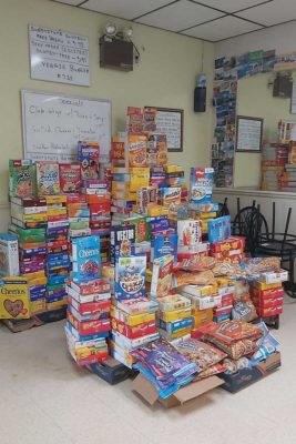 Large pile of cereal boxes in a room.