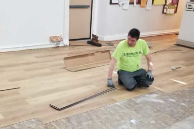 Worker laying a wooden floor