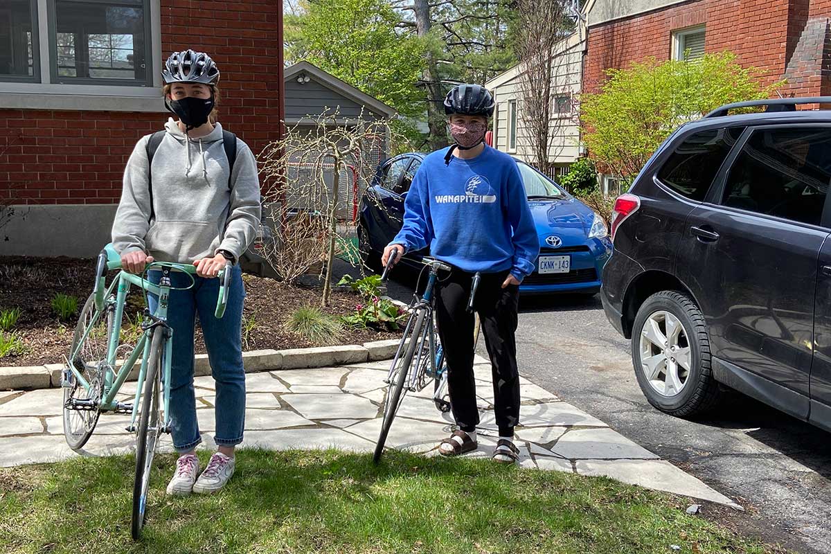 Two volunteers on bicycles