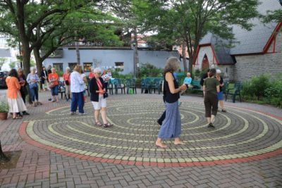 People walk the outdoor labyrinth at All Saints Westboro